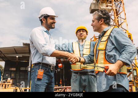 Workers team hand shaking deal with contractor happy at construction site. Engineer project business contact connection people concept. Stock Photo
