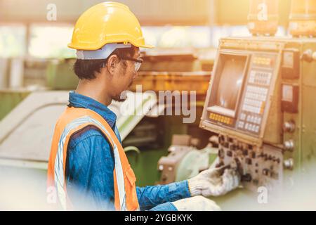 Engineer worker program setup CNC machine in metal industry factory with tablet technology. Stock Photo