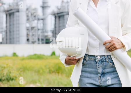 Professional Engineer Male Working Standing Against Oil Gas Refinery Industry Building Closeup Hand Holding Hard Hat. Stock Photo