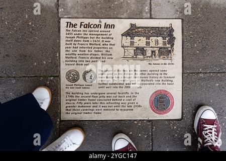 Pavement plaque, part of the Stratford (upon Avon) Society's historic spine initiative, here showing the Falcon Inn which first opened around 1655. UK Stock Photo