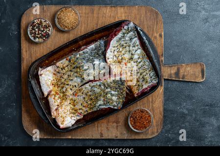 Marinated carp fish fillet with herbs and spices, close up, top view Stock Photo