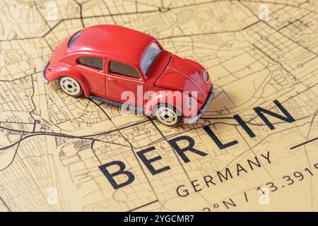 Red toy car drove into Berlin, Germany. Stock Photo