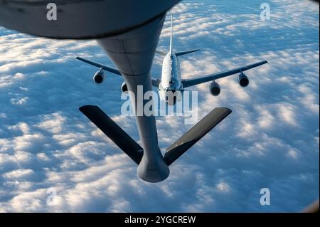 An RC-135 Rivet Joint assigned to the 95th Reconnaissance Squadron approaches a KC-135 Stratotanker assigned to the 351st Air Refueling Squadron for a Stock Photo