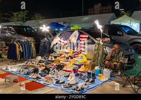 Bangkok, Thailand. 05th Nov, 2024. A seller is seen sitting at his stall installed on the ground and on his car, at The Green Vintage Market in Ratchayothin, Bangkok. The Green Vintage Market in Ratchayothin, Bangkok, is an outdoor market known for its eclectic mix of vintage goods and handicrafts. With its bohemian atmosphere, the market also features a section specializing in vintage and collectible toys, where toy collectors and enthusiasts can find rare action figures, model cars, classic dolls, anime figurines, and other nostalgic treasures. Credit: SOPA Images Limited/Alamy Live News Stock Photo