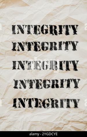Integrity written on a crushed vintage paper background. Intense integrity Stock Photo