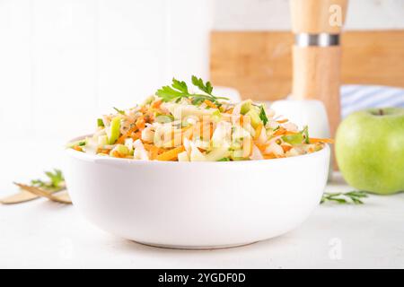 Homemade seasonal  Apple Slaw Salad with Apples, cabbage, carrot and spring onions. Healthy fall vegetable salad with yogurt dressing, in portioned bo Stock Photo