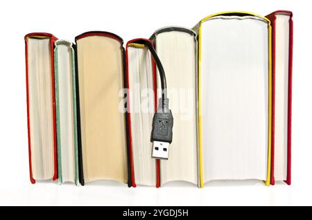Books with USB cable sticking out Stock Photo