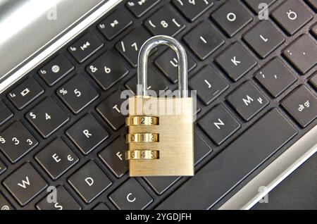 Padlock lying on computer keypad symbolizing data security Stock Photo