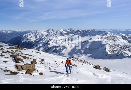 Ski tourers on a high tour on the Fuerkeleferner glacier, view of the mountain panorama, snow-covered mountain landscape in winter, ascent to Monte Ce Stock Photo