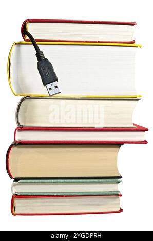 Pile of books with USB cable sticking out Stock Photo