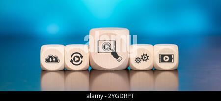 Wooden blocks with symbol of online streaming concept on blue background Stock Photo