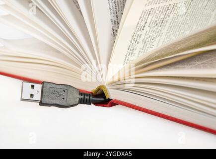 Book with USB cable sticking out Stock Photo