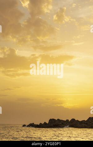 Amazing beach golden sunset orange sky, stone rocks background, copy space Stock Photo