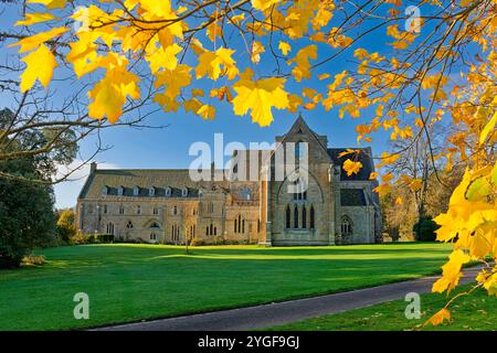 Pluscarden Abbey a Catholic Benedictine monastery near Elgin Scotland enclosed by yellow maple leaves in autumn sunshine Stock Photo