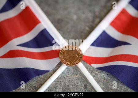2p coin, His Royal Highness King Charles III, on the two Union Jack Flags Stock Photo