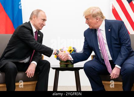 VLADIMIR PUTIN , Russian President at left with US President Donald Trump during the G20 meeting in Japan, 28 June 2019. Photo: White House Stock Photo