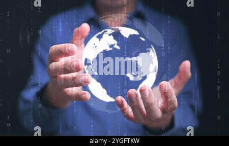 whole world in your hands concept. Digital globe in a businessman's hand with binary code representing the man can use and access communication, infor Stock Photo