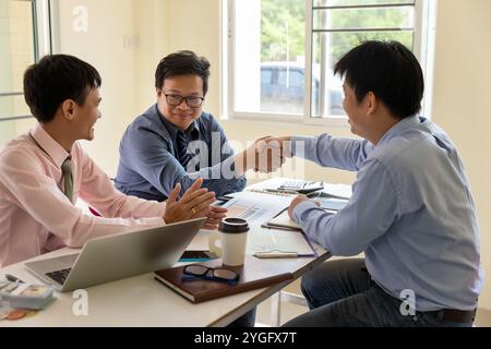 Business people shaking hands, finishing up a meeting. The confident business man shaking hands during a meeting in the office, success, dealing, gree Stock Photo