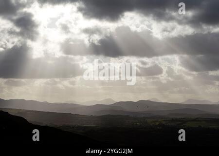 sunlight breaking through clouds with views over the derryveagh mountains viewed from ballymastocker viewpoint , county donegal, republic of ireland Stock Photo