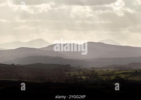 sunlight breaking through clouds with views over the derryveagh mountains viewed from ballymastocker viewpoint , county donegal, republic of ireland Stock Photo