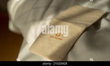 Disposable eco-friendly napkins made of recycled paper for reuse Napking made of recycled paper in brown color against white background. Stock Photo