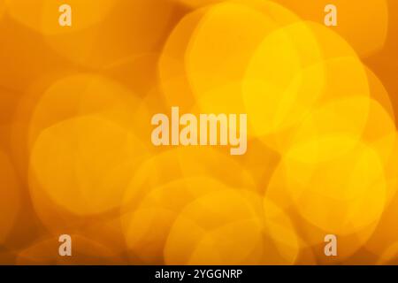 Abstract Orange Bokeh with blurred background nature blurry light party in vintage style warm shimmering. Festive lights bokeh. Stock Photo