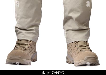 Beige tactical desert boots and durable ripstop pants, khaki tan suede leather army combat footwear and casual men's trousers, brand new apparel detai Stock Photo