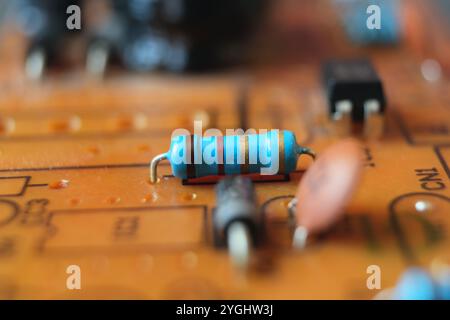 Close up of an electrical resistor on the electronic circuit board. Stock Photo
