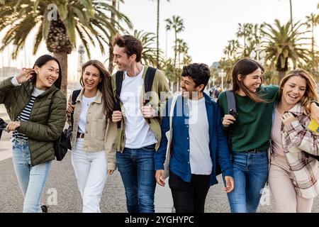 College students walking together and talking in Barcelona, Spain Stock Photo
