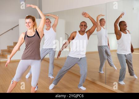 Young adults practicing dance movements in choreography class Stock Photo