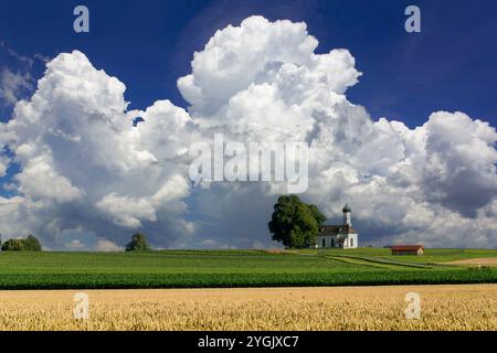 Cumulus clouds over the chapel of St Andrae Etting, Germany, Bavaria, Weilheim Stock Photo
