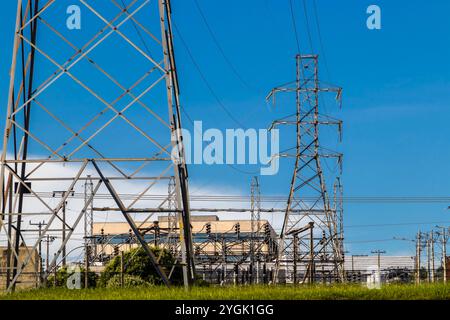 High voltage towers against blue sky background in Brazil Stock Photo