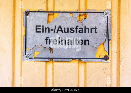 Warning sign with the words 'Keep entrance and exit clear' on a garage door Stock Photo