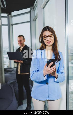 Two business people working remotely online using a laptop. Colleagues work remotely in the workspace. Stock Photo
