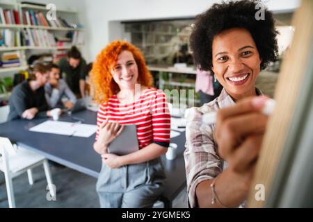 Young businesswoman leading a discussion during a meeting with her colleagues. Stock Photo