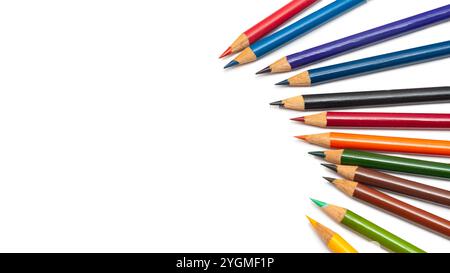 Numerous colored pencils in various shades are laid out in a creative arrangement on a white background, ideal for artistic endeavors Stock Photo