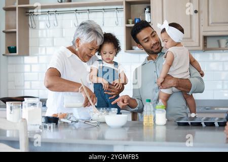 Happy family, baking and children in kitchen for learning, development and making cupcakes for Thanksgiving. Grandma, man or kids at home with Stock Photo