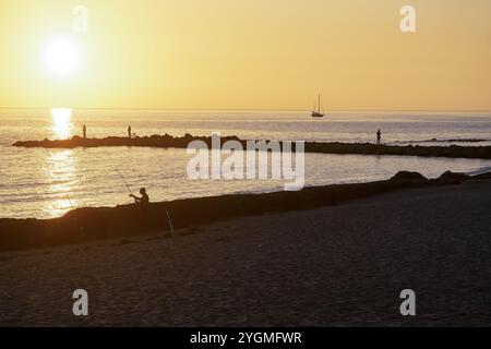fishermen at sunset on the beach of Ostia near Rome Stock Photo