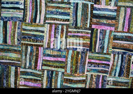 A patchwork quilt with many different colored squares. Abstract background Stock Photo