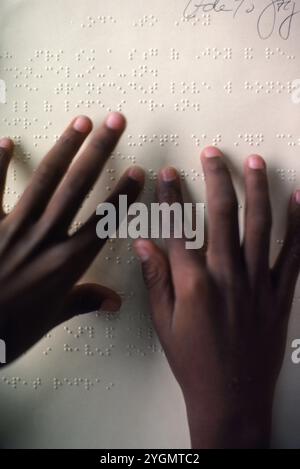 Blind person reading braille music. Stock Photo