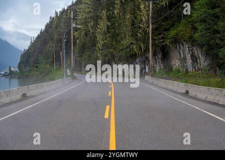 Cassiar Highway landscape with mist between Stewart, Canada and Hyder, Alaska, USA. 300 meters before the Canadian - American border. Stock Photo