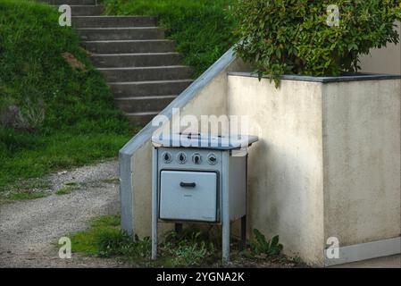 St Germain Les Belles, Hautes Vienne, France - November 6th 2024 - Old fashioned enamelled and painted blue oven outside Stock Photo