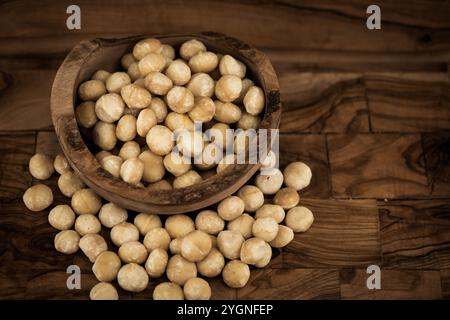 Macadamia nuts Macadamia tetraphylla on olive wood Stock Photo