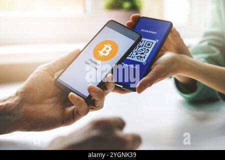 bitcoin payment - person using smart phone to pay with crypro Stock Photo