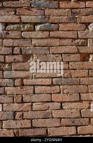 Background with old wall made with handmade brick made out of clay. Stock Photo