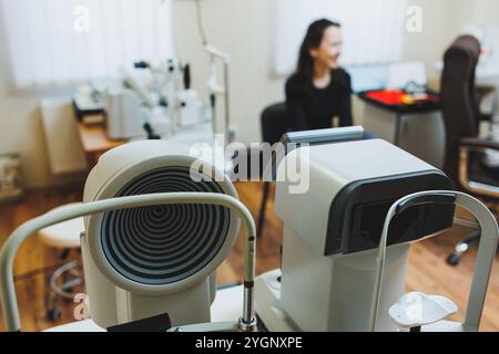 Eye examination of a young woman at an ophthalmologist's appointment using modern microscopes. Vision treatment using modern equipment Stock Photo