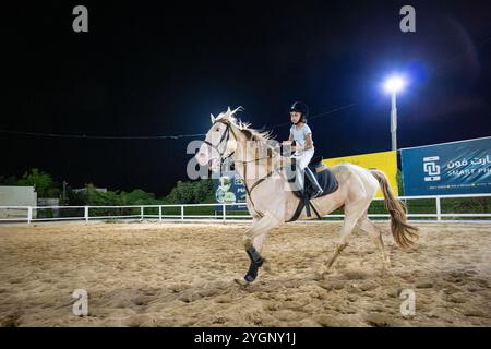 Gaza, Gaza Strip, Palestine, July 20, 2023 — Confident Little Girl Rides a Horse in the Arena at Nighttime Stock Photo