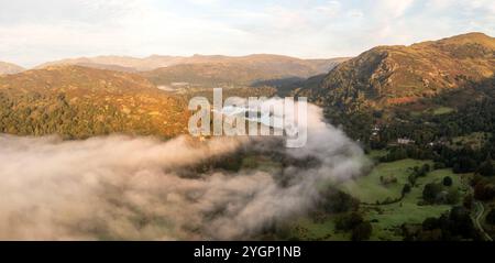 Aerial panoramic landscape of low lying mist or cloud inversion over Grasmere and Rydal Water lakes in  the Lake District National Park on a cold Autu Stock Photo