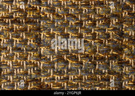 close up macro detail of woven chenille cloth in yellow, gray and golden tones with shallow depth of field Stock Photo