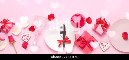 Romantic table setting and decorations for Valentine's Day on pink background, top view Stock Photo